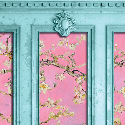 A close-up of decorative wall paneling featuring a pink floral artwork with pale blossoms and branches, framed in distressed turquoise molding.