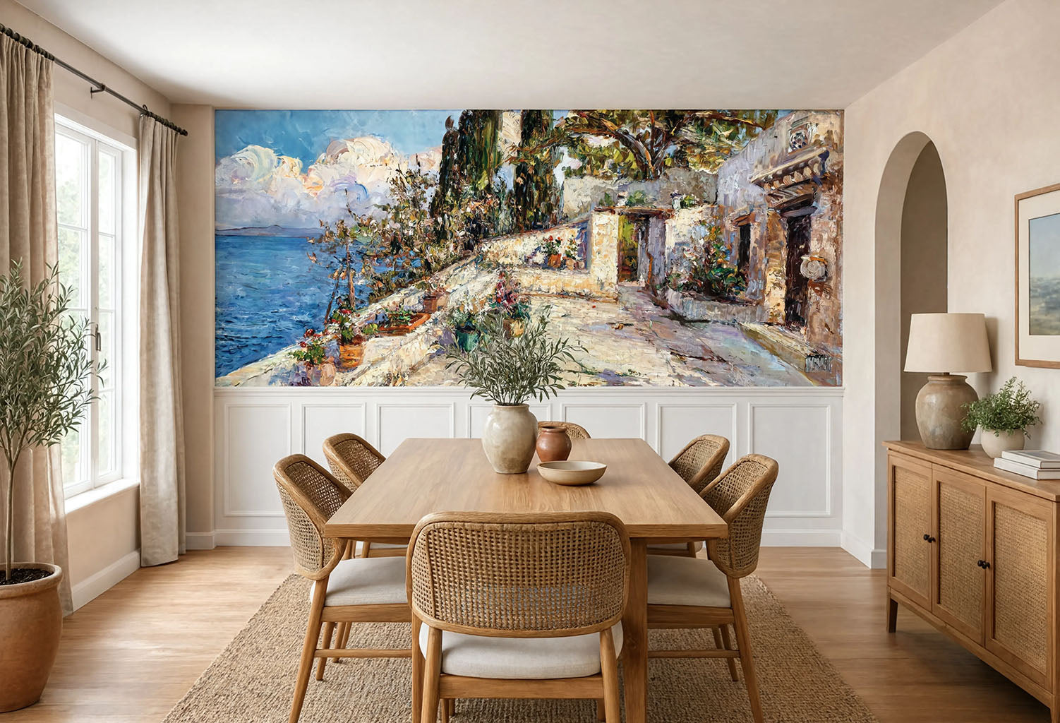 Large panoramic vintage wallpaper mural with heavy texturized brushstrokes of a Mediterranean coast, installed above white wood wainscoting in a dining room.