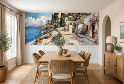 Large panoramic vintage wallpaper mural with heavy texturized brushstrokes of a Mediterranean coast, installed above white wood wainscoting in a dining room.