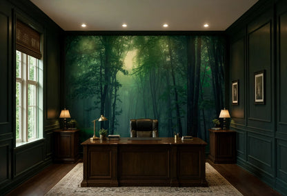 A dark, elegant Dark Academia office room featuring a large wall mural of a misty green forest as the primary backdrop, with a dark wood desk, leather chair, side tables, and lamps.