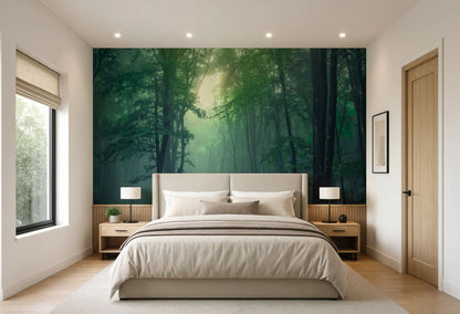 A modern bedroom featuring a large wall mural of a misty green forest behind a bed with beige bedding, flanked by two wooden nightstands and a window on the left.