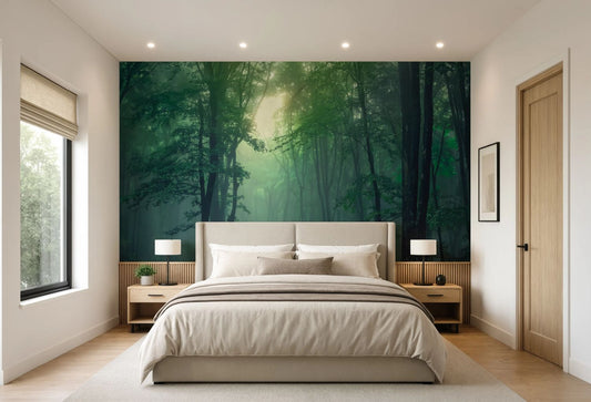A modern bedroom featuring a large wall mural of a misty green forest behind a bed with beige bedding, flanked by two wooden nightstands and a window on the left.