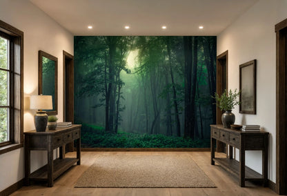 A large wall mural depicting a misty green forest with sunlight filtering through trees, installed on the back wall of a modern hallway with dark wood console tables and a beige rug.