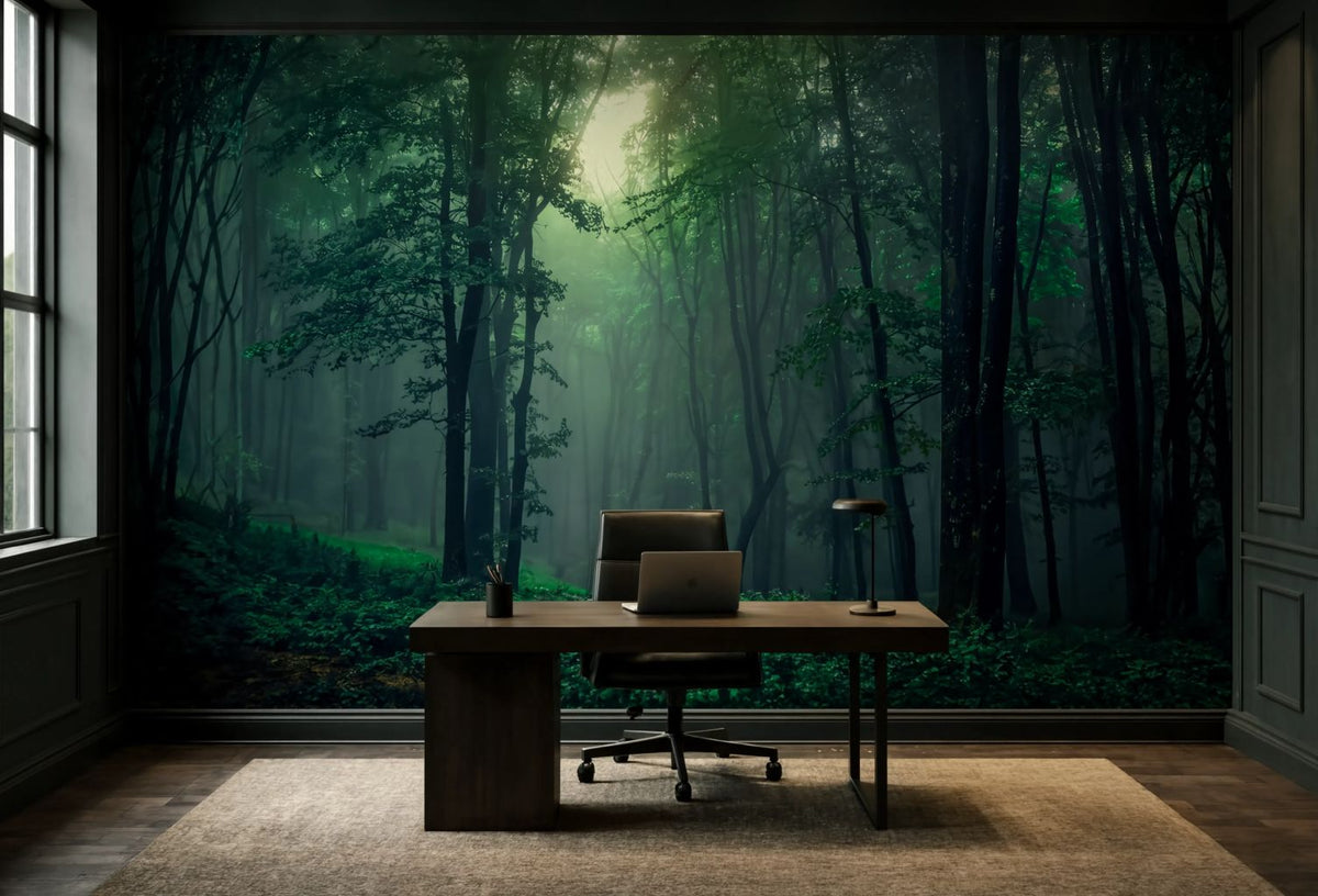 A large wall mural depicting a misty green forest with tall trees and soft sunlight, installed in an office setting behind a wooden desk and chair.