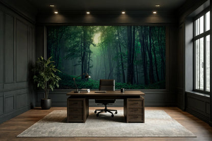 A large wall mural depicting a misty green forest is displayed on the back wall of a modern office room with dark wood paneling, a wooden desk, and a black office chair.