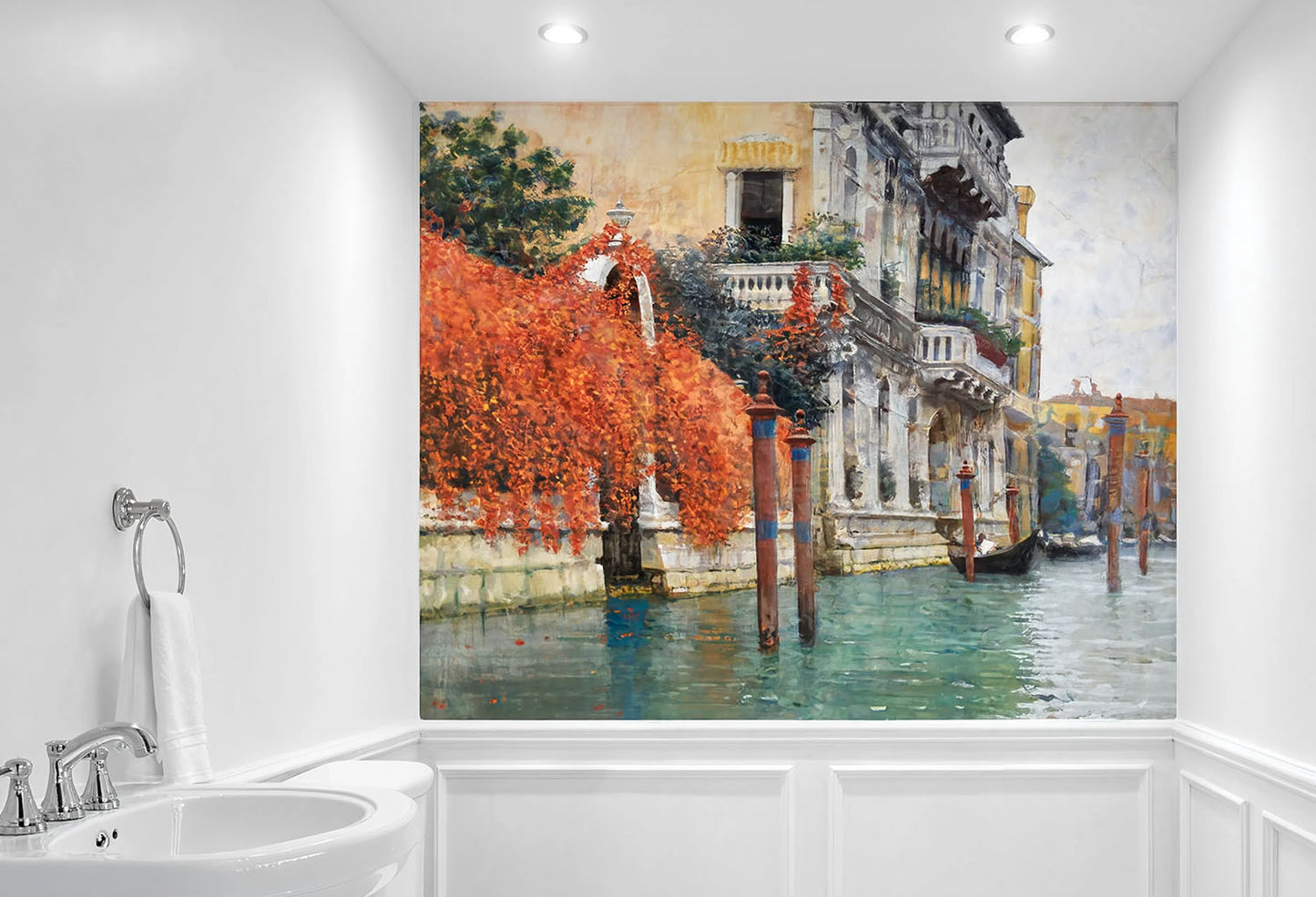 A large wall mural depicting a Venetian canal scene with orange-red foliage, historic buildings, and gondolas, shown installed on a bathroom wall above a white sink and wainscoting.