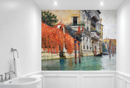 A large wall mural depicting a Venetian canal scene with orange-red foliage, historic buildings, and gondolas, shown installed on a bathroom wall above a white sink and wainscoting.
