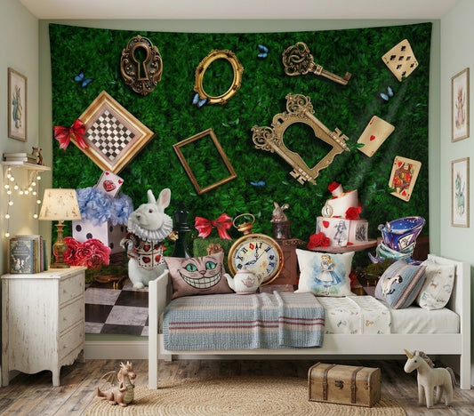 A styled children's bedroom featuring a large green Alice in Wonderland themed wall tapestry as the main background. The room is decorated with various Alice in Wonderland props including a Cheshire Cat pillow, a white rabbit plush, a chessboard, and a vintage-style bed.