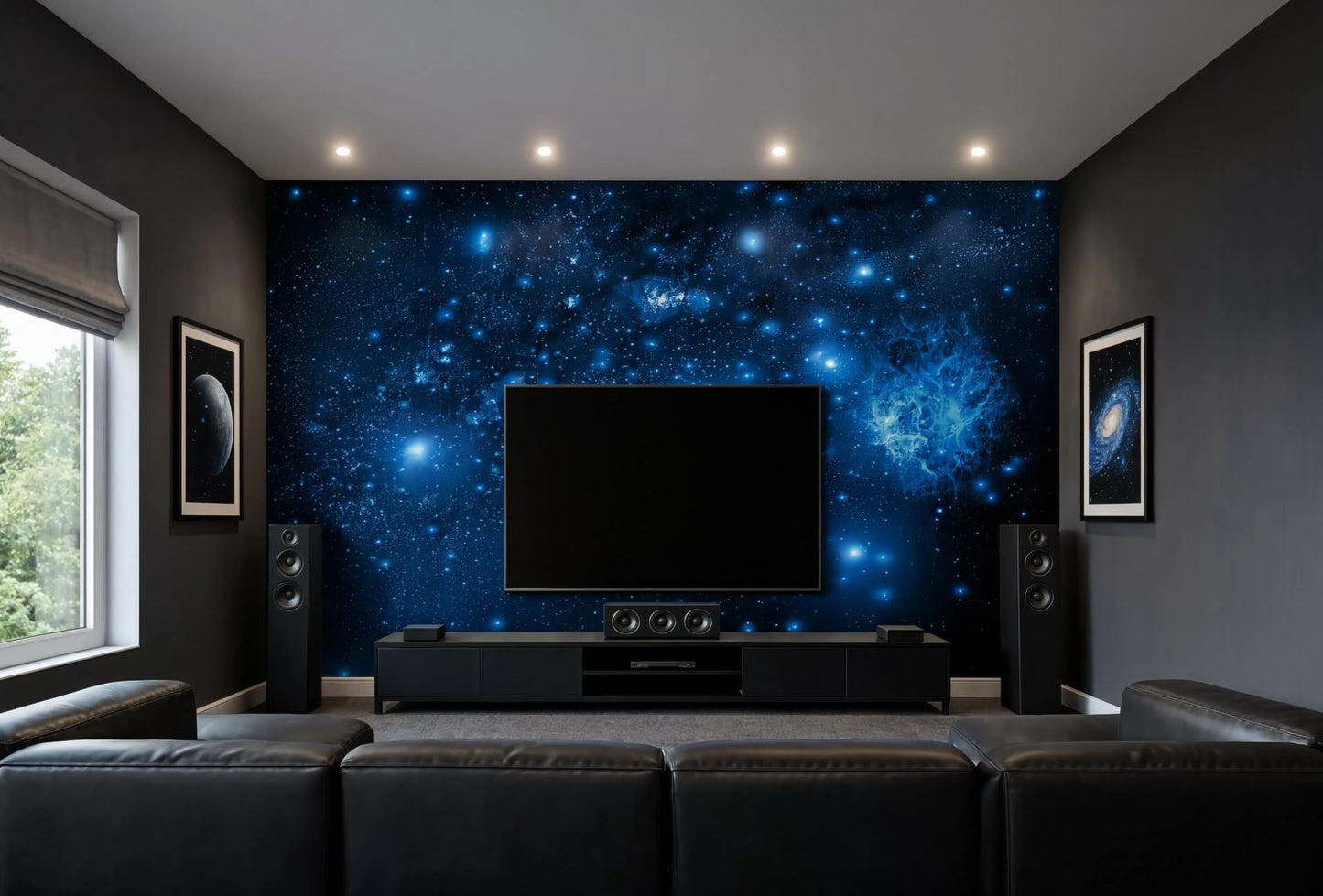 A home theater room featuring a large wall mural with a blue and black galaxy space design behind a black TV, flanked by black speakers and framed wall art, with a dark leather sofa in the foreground.