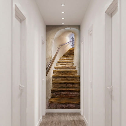 A hallway with white walls and doors, featuring a large wall mural of a rustic wooden staircase leading up an arched stone staircase in the distance.