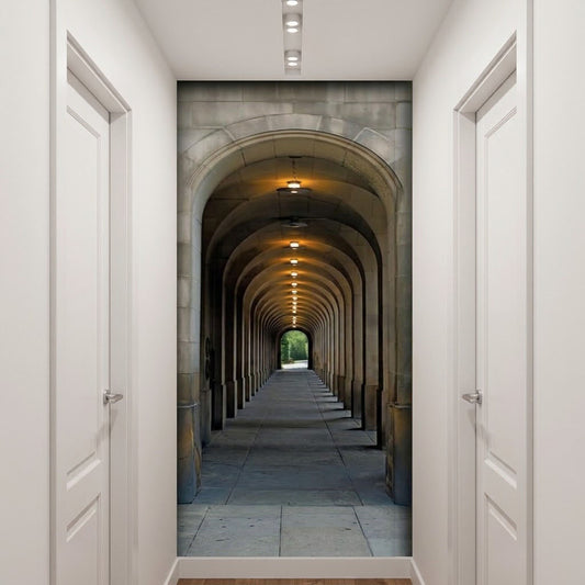A hallway decor idea with a large wall mural or wallpaper panel in the center depicting a stone arch tunnel with warm ceiling lights and a green opening at the end.