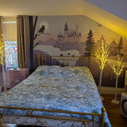Bedroom with a decorative wall mural of a castle and trees