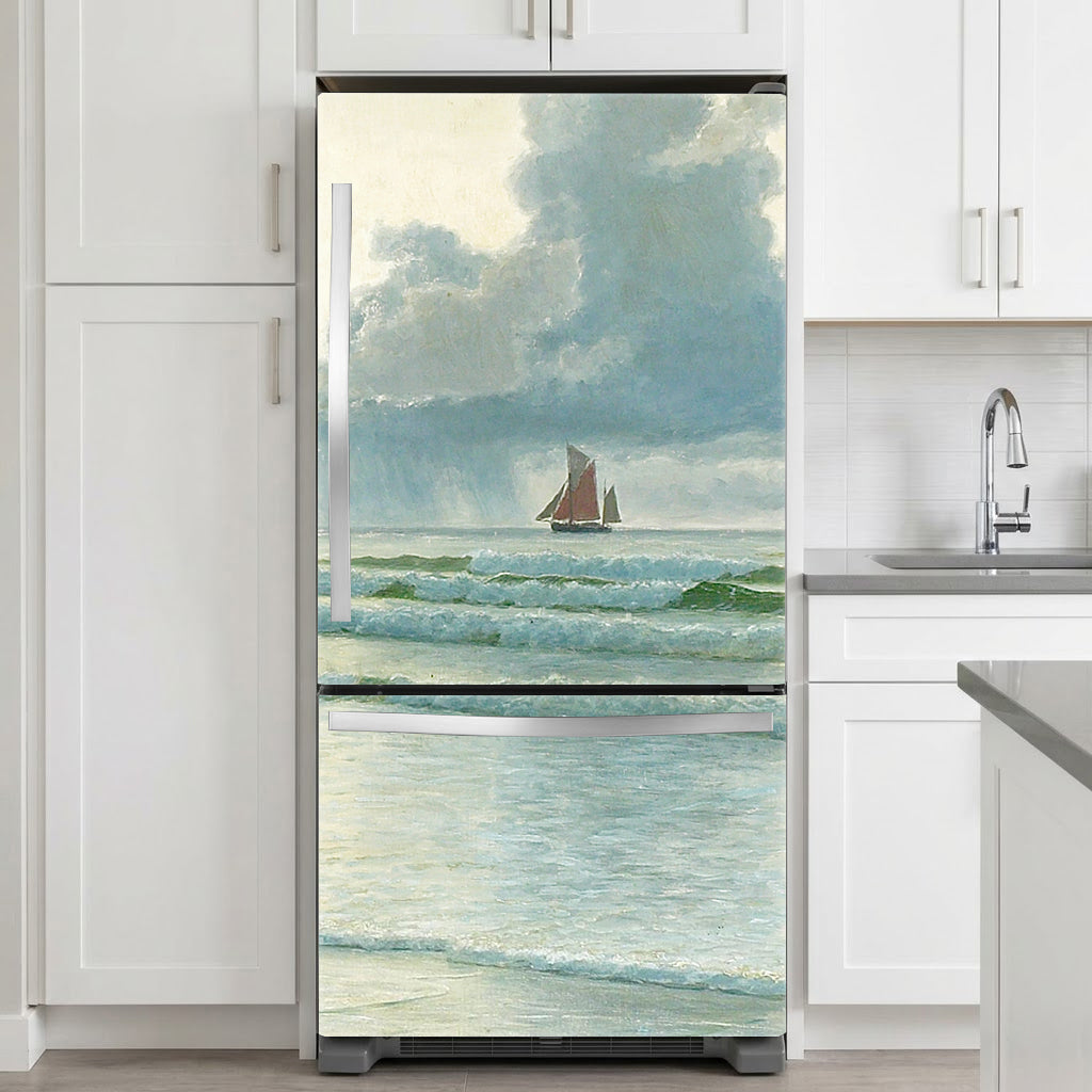 Fridge with a decorative vinyl wrap of a sailboat scene in a kitchen.