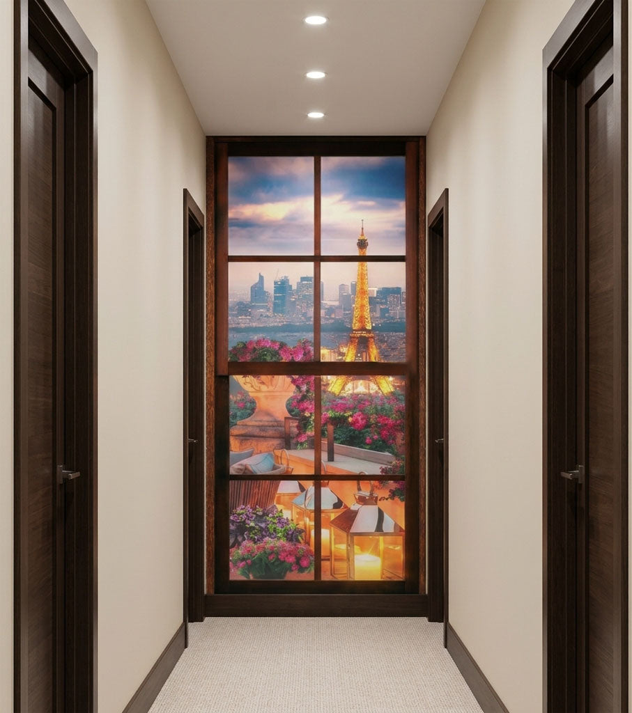 A hallway with cream walls and dark wood doors, centered on a large decorative glass panel showing a Paris cityscape with the Eiffel Tower, flowers, and a sunset sky.