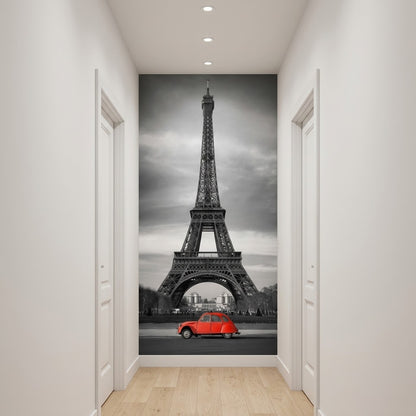 Ideas for hallway decor. A large wall mural depicting the Eiffel Tower in Paris with a small red car at the bottom, displayed on a hallway wall above light wood flooring.