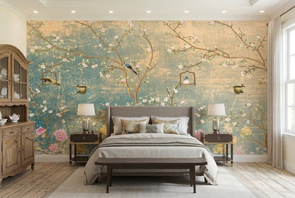 A styled bedroom featuring a large wall mural with a vintage-style floral and bird design in muted teal, beige, and pink tones. 