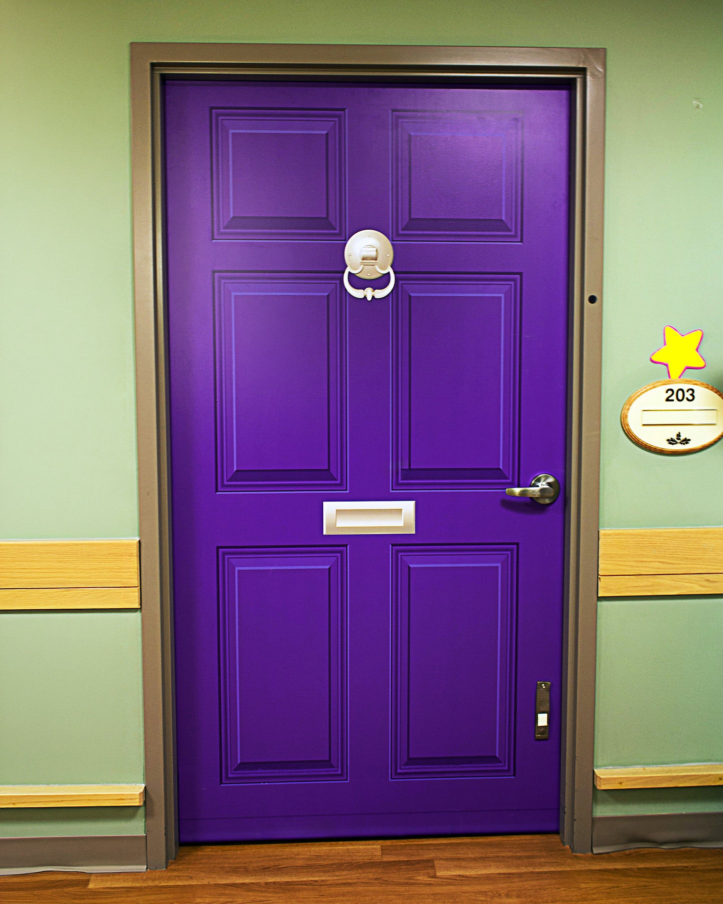Purple door wrap with a gold handle for dementia friendly homes